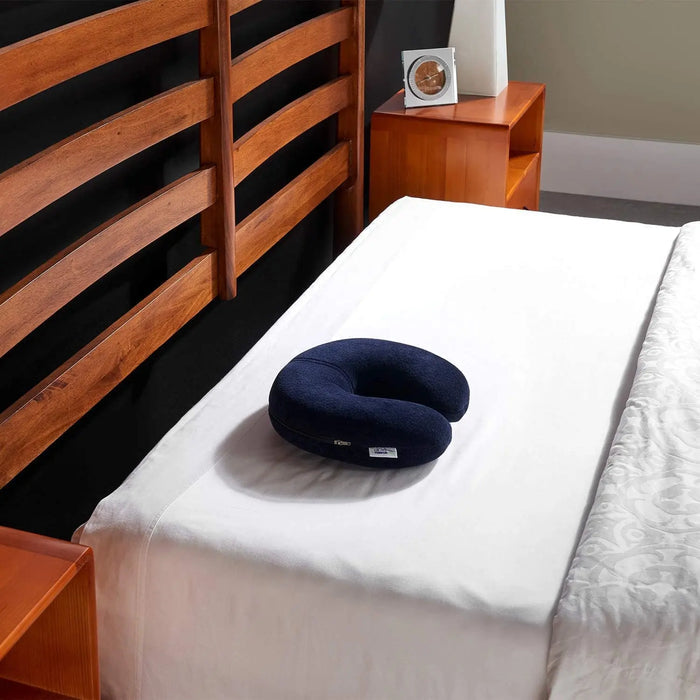 Tempur Pedic Travel Neck Pillow shown on a bed