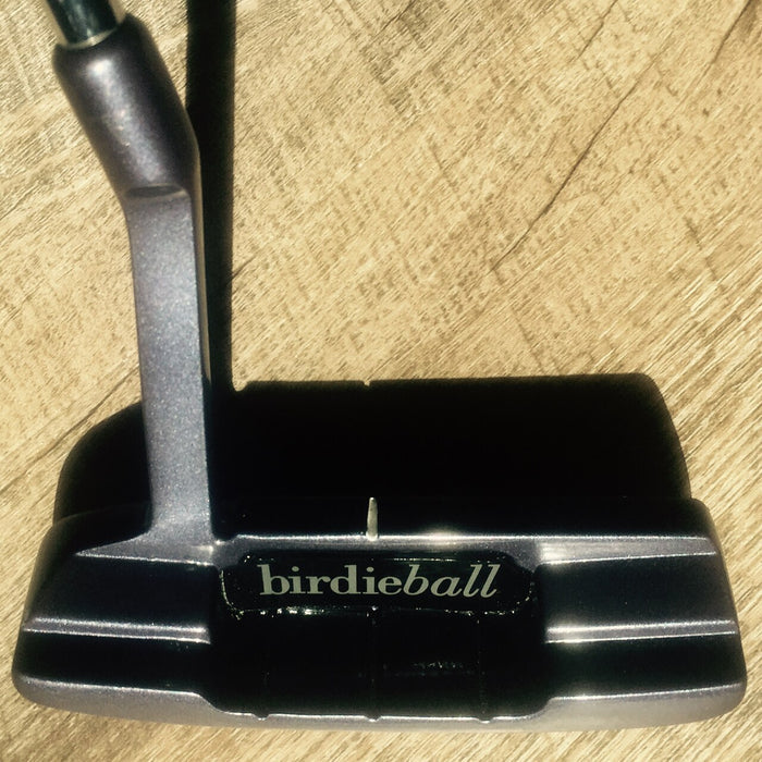 A close-up of an American Classic Putter (Anser Style, Milled Face, Heel/Toe Weighted) by BirdieBall resting on a wooden surface, with the brand name displayed on the putter’s face.