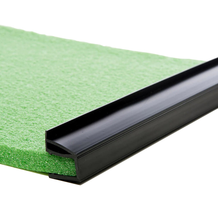 Close-up of BirdieBall Bumpers (Set of 2)—black plastic edging strips fitted onto the edge of a green BirdieBall Putting Green sheet, serving as a golf ball stop for matting or flooring installations.