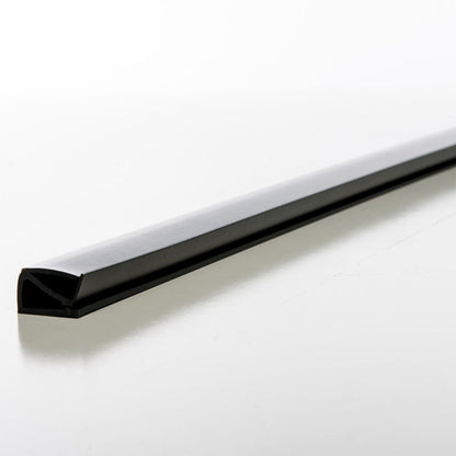 A black, angled heavy rubber BirdieBall Bumper from the Set of 2 is shown on a white surface, photographed from a low side angle—perfect as a golf ball stop for your BirdieBall Putting Green.