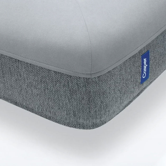 Gray mattress cover with a visible Casper logo on a white background