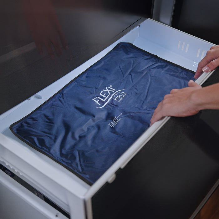 Blue cold pack with 'FLEXI' branding being placed into a freezer.