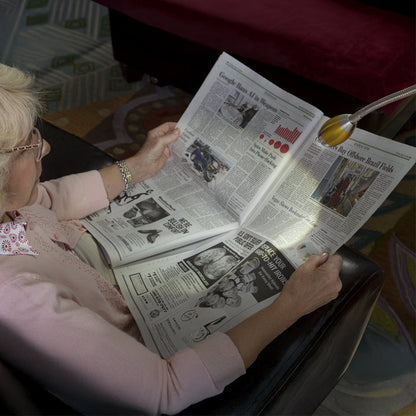 Woman using the FOCUS Adjustable Beam Floor Lamp