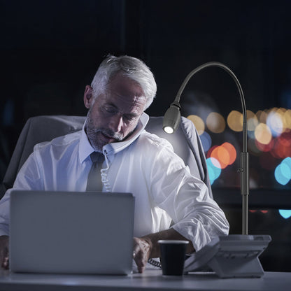 Man using the FOCUS Adjustable Beam Floor Lamp