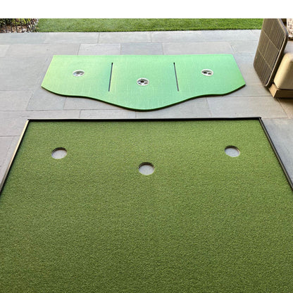 A BirdieBall Full Width Hole Deepening/Break Shim (for use with turf mats) lies disassembled on a stone patio, featuring Tour Grade Turf, a detached curved top piece, and three visible holes.