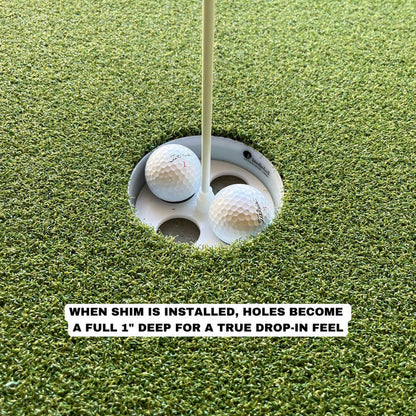 Two golf balls in a putting green hole, showing how the BirdieBall Full Width Hole Deepening/Break Shim for Turf Mats makes the cup one inch deeper for a true drop-in experience.