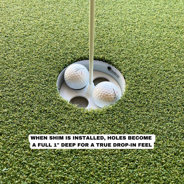 Two golf balls in a putting green hole, showing how the BirdieBall Full Width Hole Deepening/Break Shim for Turf Mats makes the cup one inch deeper for a true drop-in experience.