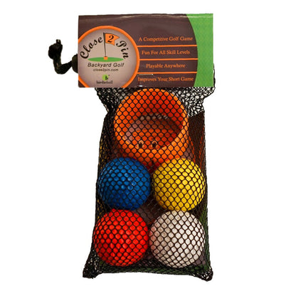 The BirdieBall Golf Chipping Game - Backyard Golf Game Close 2 Pin includes a mesh bag with five colored balls (red, blue, orange, yellow, white) and an orange cup—perfect for backyard fun.