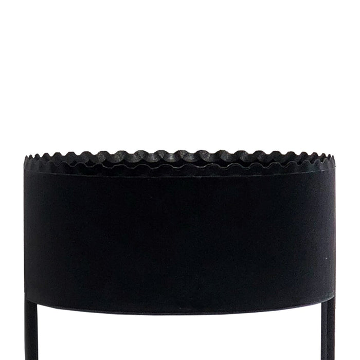 The BirdieBall Golf Hole Cutter is a black cylindrical metal planter with a scalloped top edge and two vertical legs, resembling a putting green hole cutter, shown against a white background.