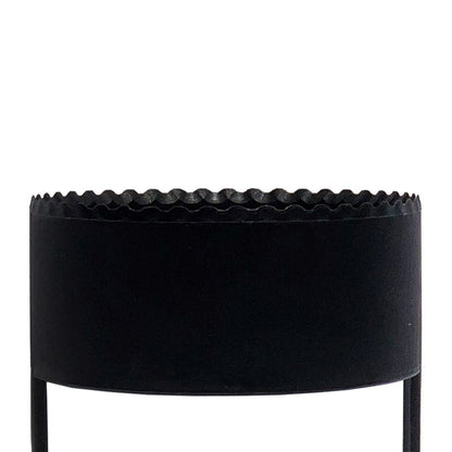 The BirdieBall Golf Hole Cutter is a black cylindrical metal planter with a scalloped top edge and two vertical legs, resembling a putting green hole cutter, shown against a white background.