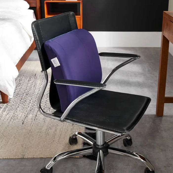 The LumbarCushion by Tempur-Pedic shown on a chair in a bedroom setting.