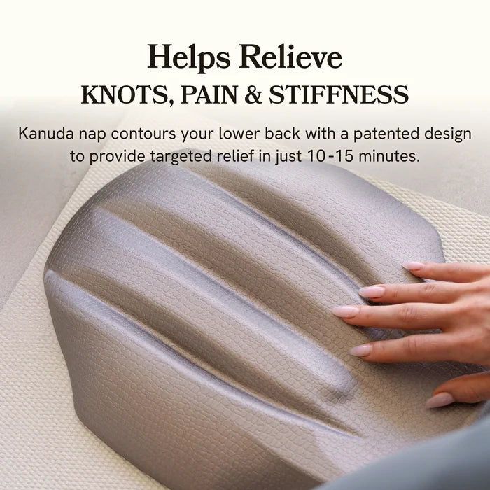 Kanuda nap cushion being used to relieve knots, pain, and stiffness with a hand on top.