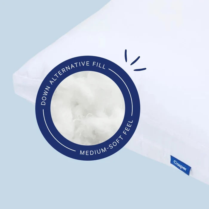White pillow with a label on a light blue background