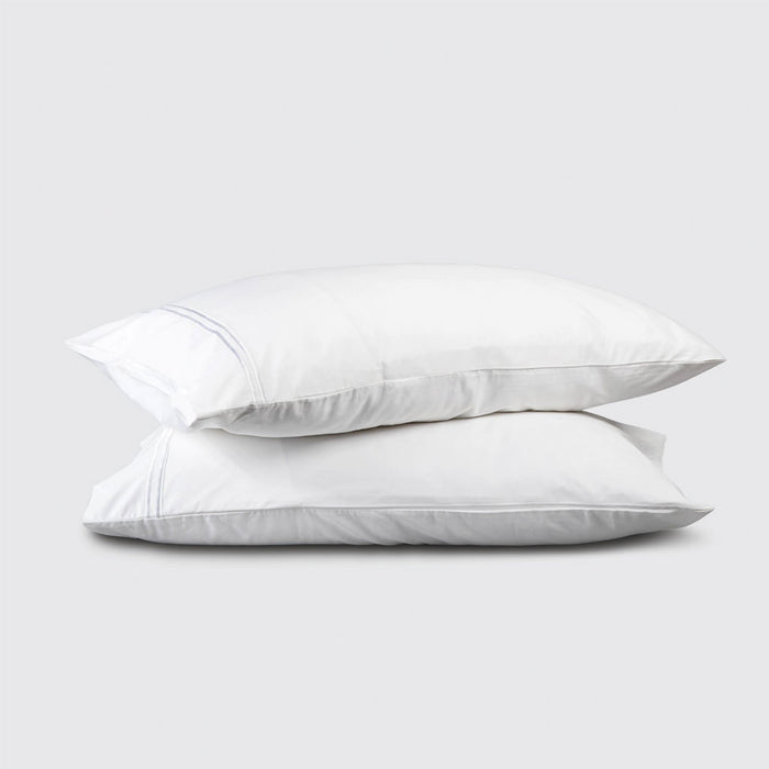 Two white pillows stacked on a light gray background