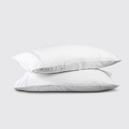 Two white pillows stacked on a light gray background