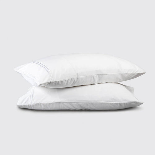 Two white pillows stacked on a light gray background