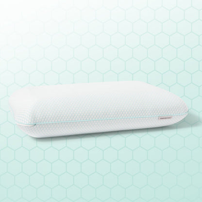 White pillow with a textured surface on a light green hexagonal patterned background