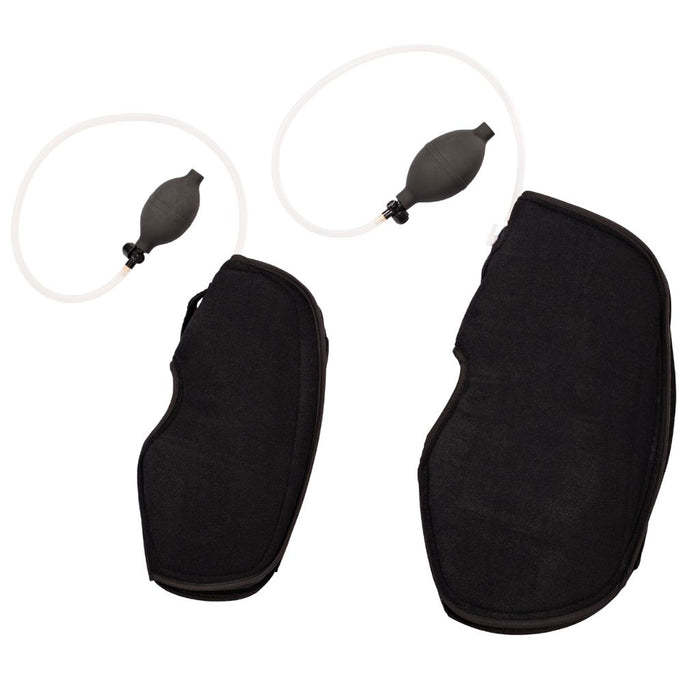 Two black knee suppports shown with small black pump bulb and clear tubing, photographed on a plain white background.