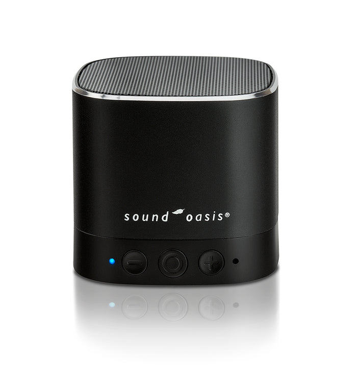 A black Sound Oasis portable Bluetooth speaker, white logo text, and three control buttons on a reflective white surface.