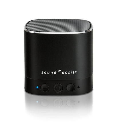 A black Sound Oasis portable Bluetooth speaker, white logo text, and three control buttons on a reflective white surface.