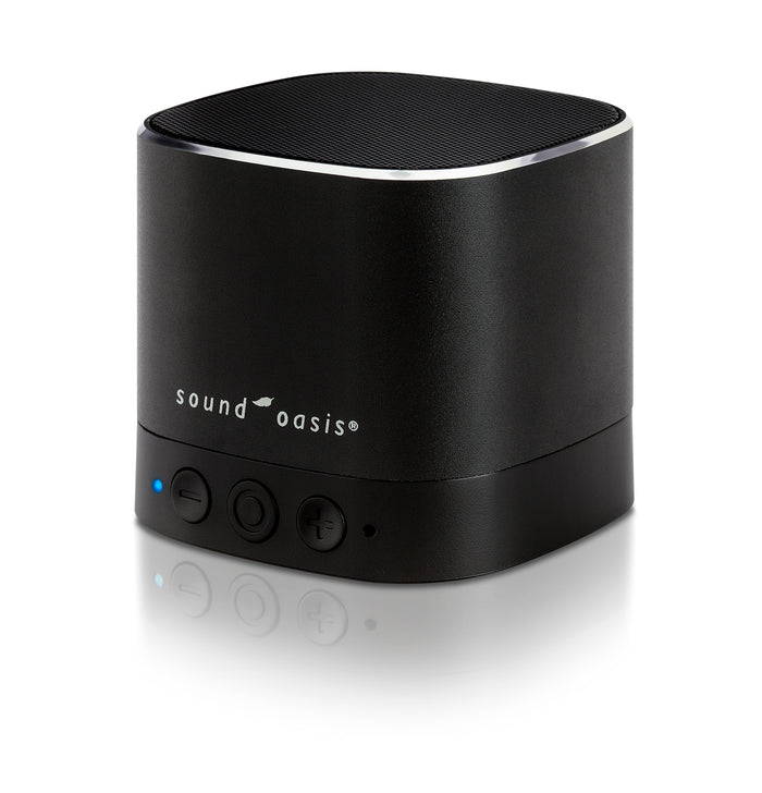 A black Sound Oasis portable Bluetooth speaker with a cylindrical design, featuring a textured top grille, a silver accent ring, and three control buttons on the front, set against a clean white background with a soft reflection.
