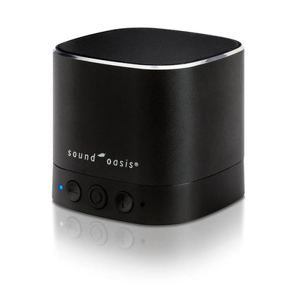 A black Sound Oasis portable Bluetooth speaker with a cylindrical design, featuring a textured top grille, a silver accent ring, and three control buttons on the front, set against a clean white background with a soft reflection.