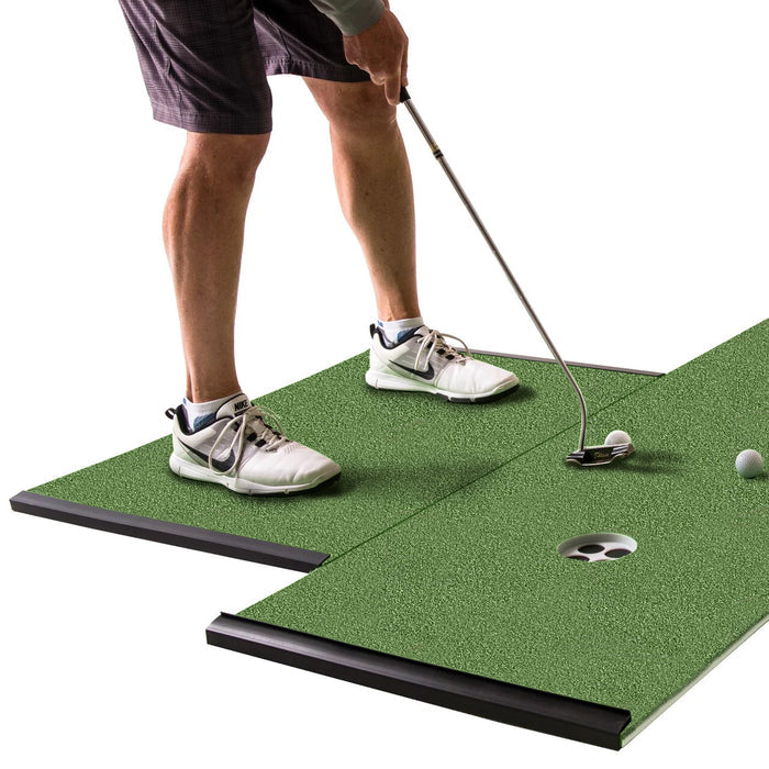 A person stands with one foot on each BirdieBall Golf Stance Mat (Options Available), places a golf ball on an indoor foam putting green, and aims for the golf hole just ahead.