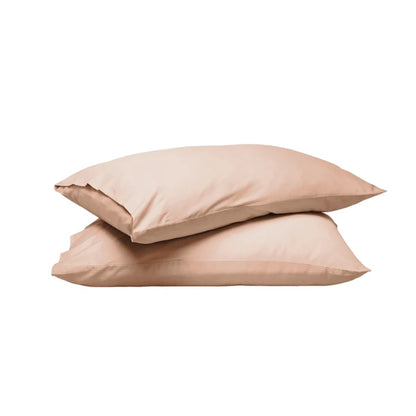 Two plain pillowcases stacked on a white background, in a soft warm beige or blush-tan tone.