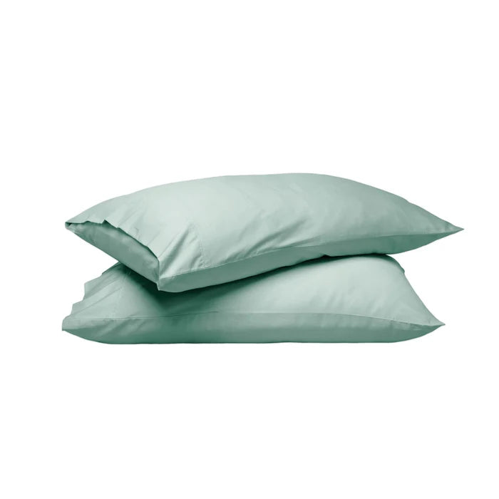 Two mint green pillowcases stacked on a solid white background.