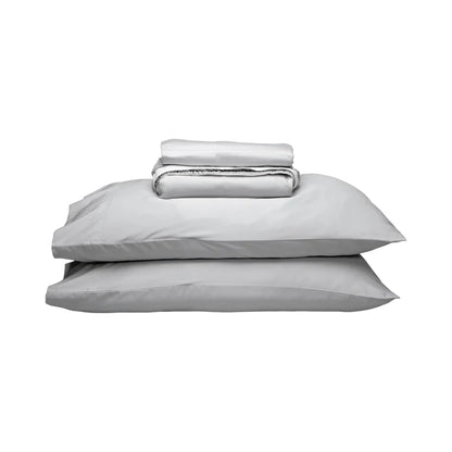 A stack of light gray bedding, including two pillows and a folded matching sheet, photographed on a plain white background.